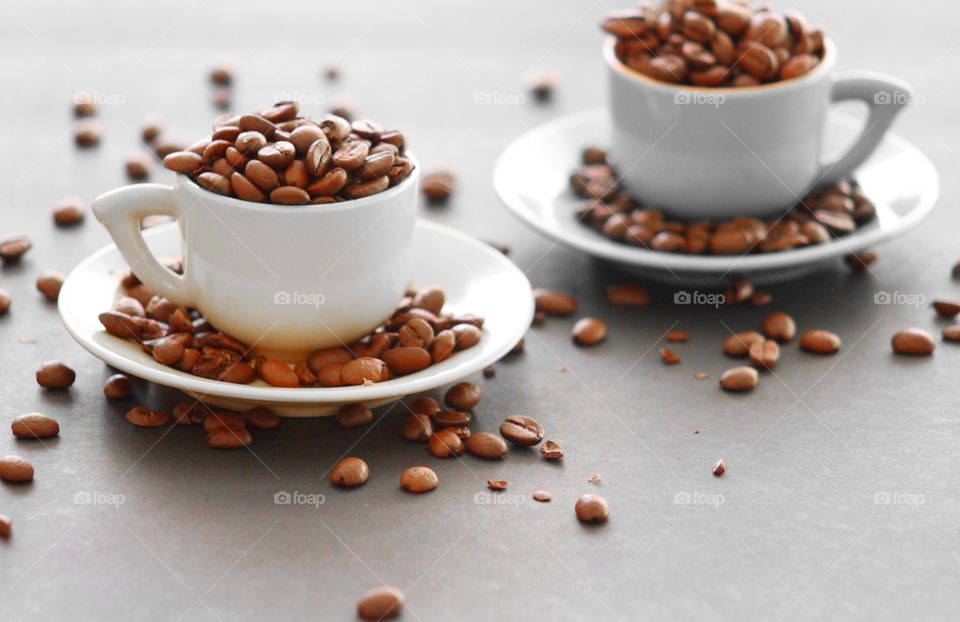 Roasted coffee beans on coffee cup