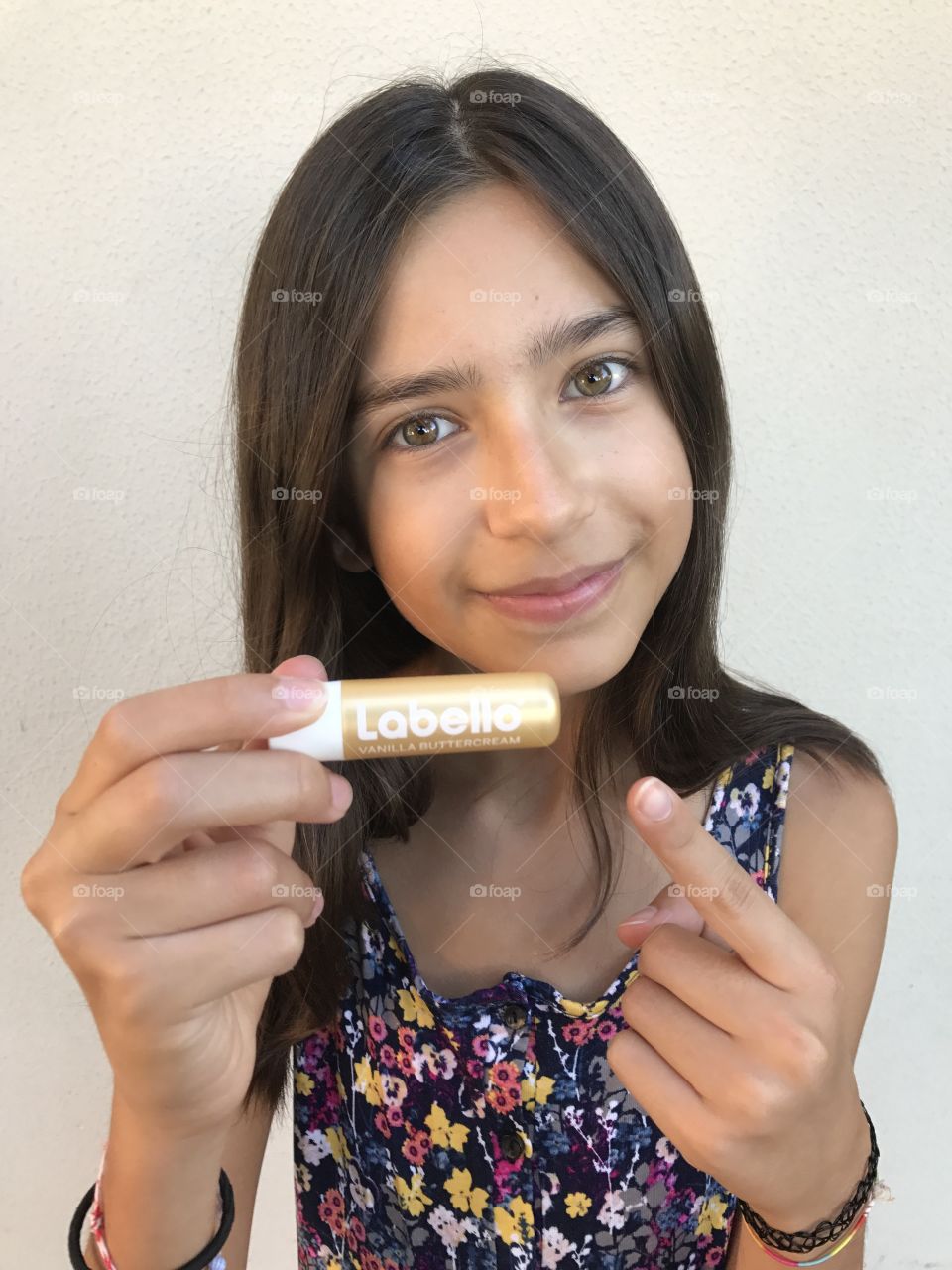 Young girl showing her nivea label