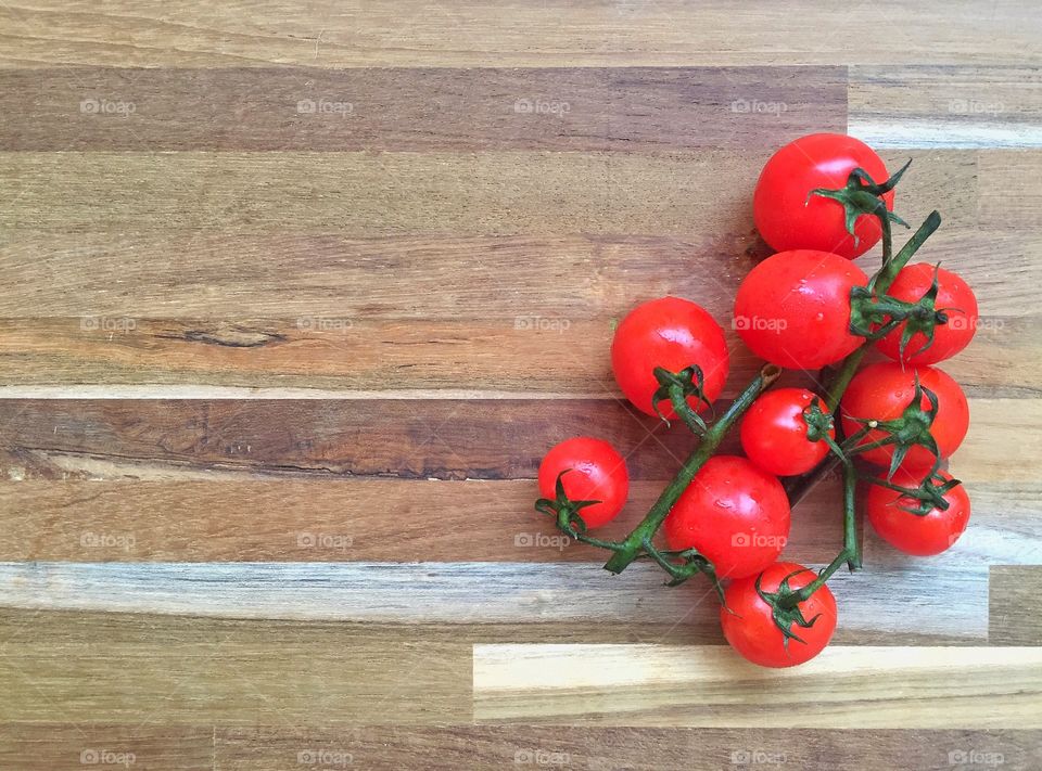Tomatoes on wooden background with copy space 