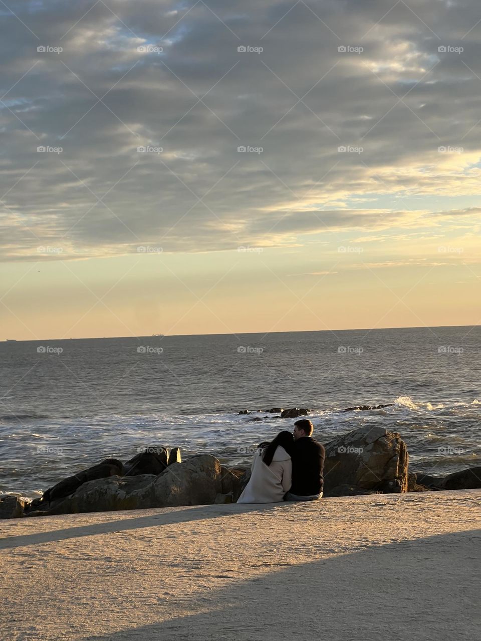 Couple in the sunset by beach