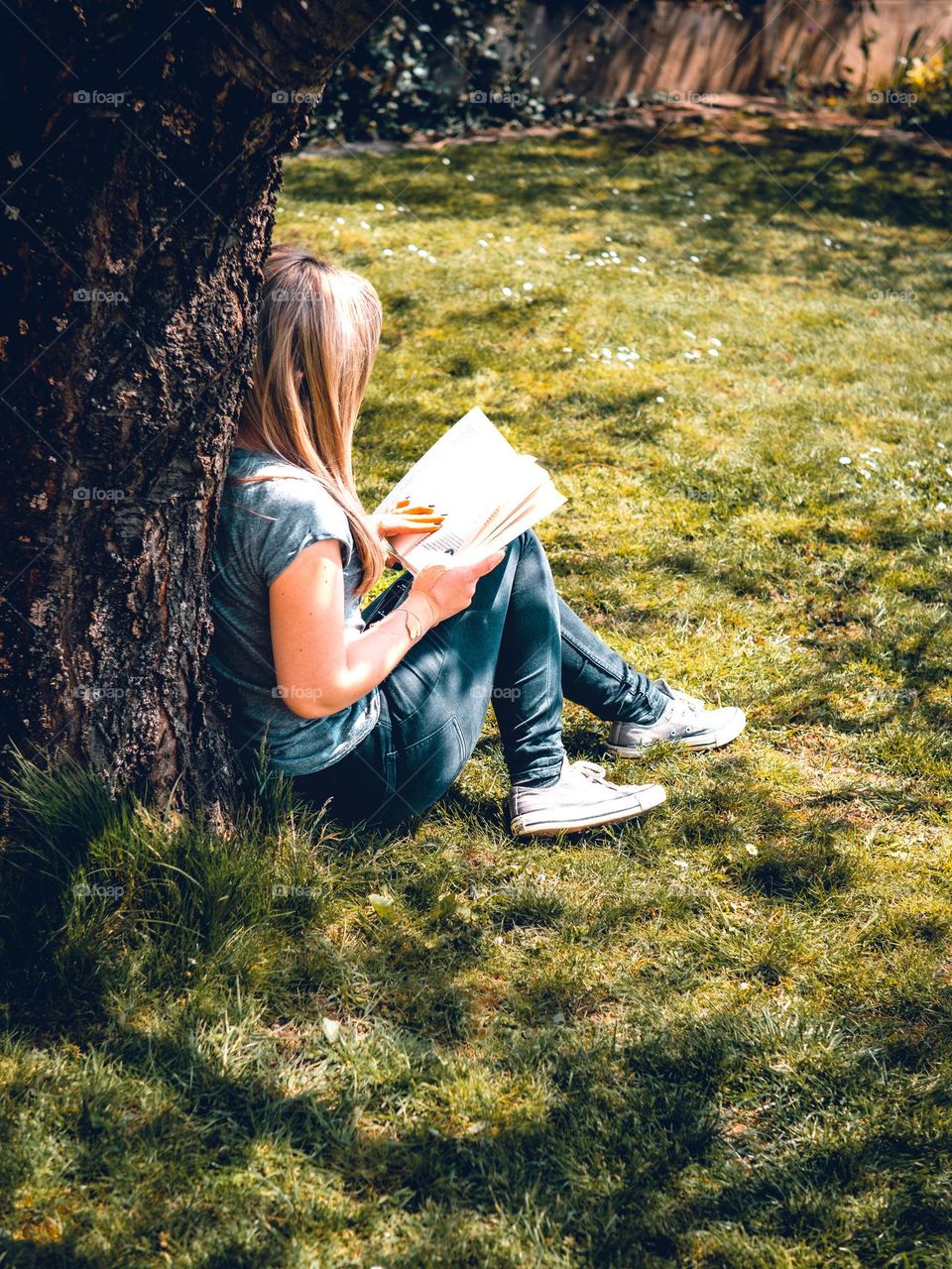 A young woman reading outdoors