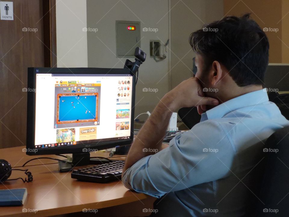 an office employee in front of his computer screen.