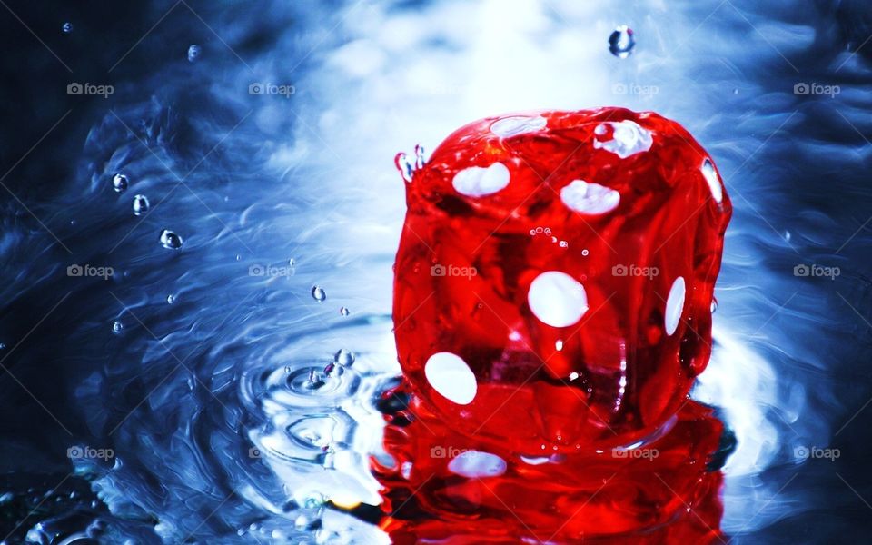 I was playing a game of dice with my parents when it started to rain we packed everything up but we forgot some dice outside so after looking at the table and just seeing the water on the dice gave me an idea for a picture
