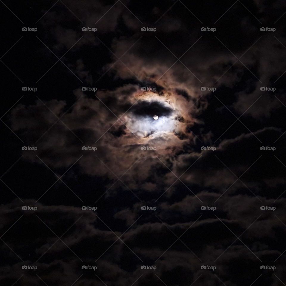 Moon light in the middle of the clouds.