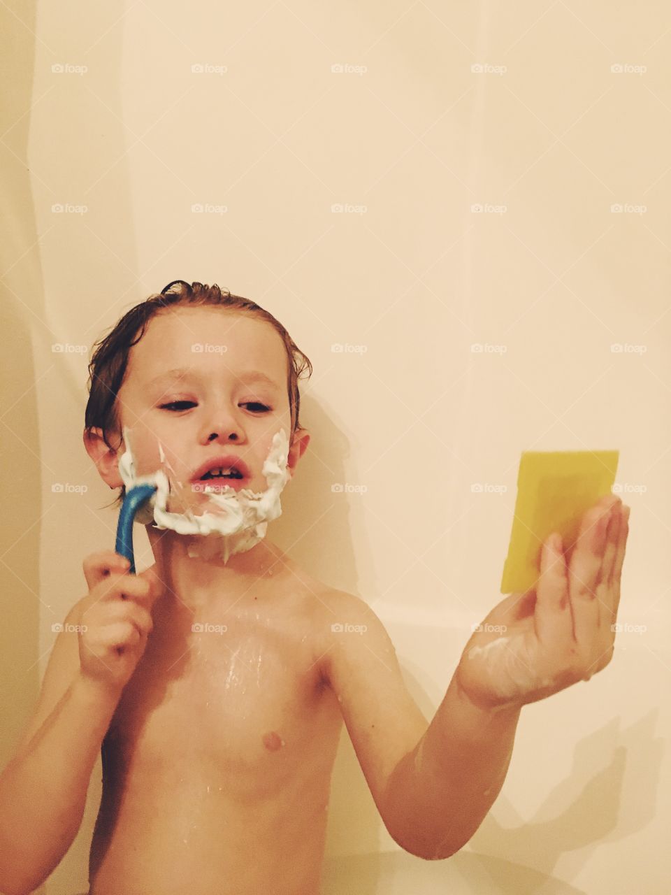 Little boy learning to shave