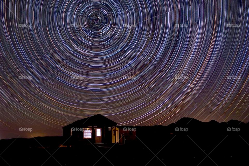 Star trails with house, New Mexico