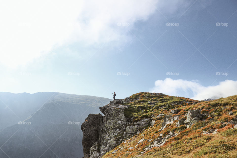 man standing close to the verge of the cliff