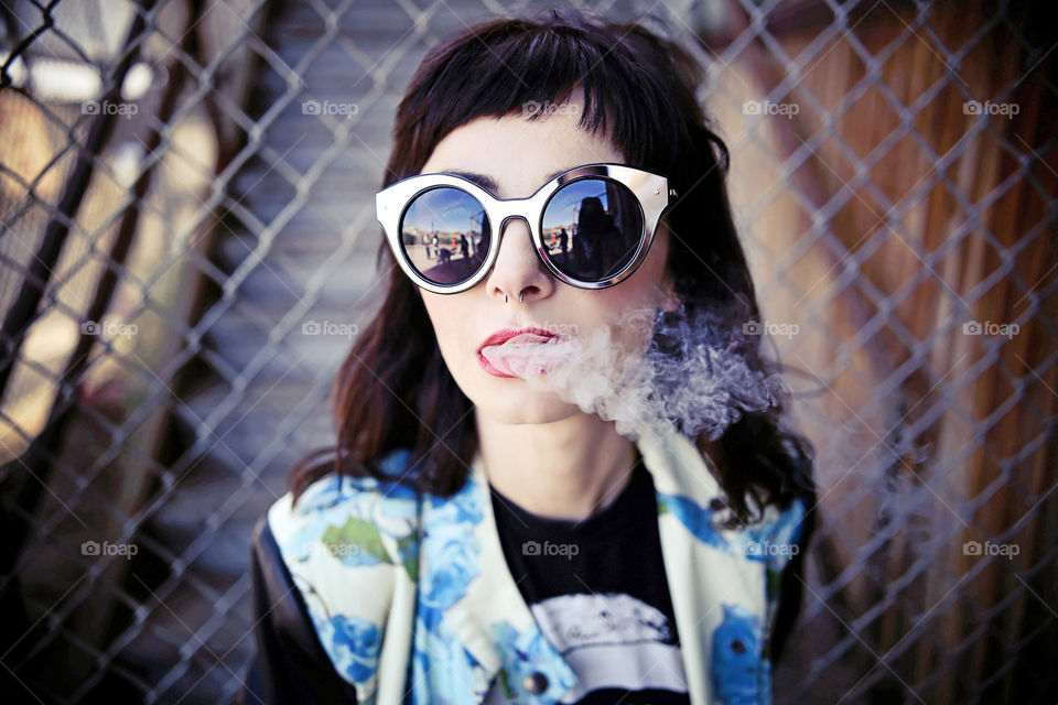 Close-up of a teenage girl smoking