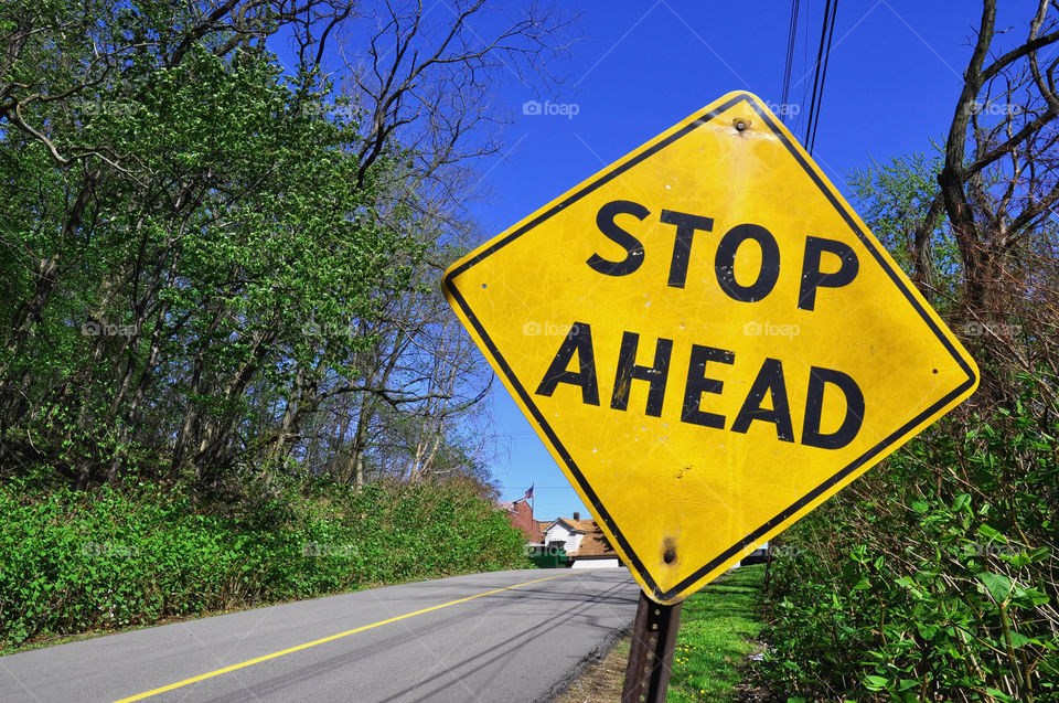 Sign . Residential street with. Stop ahead caution sign. 