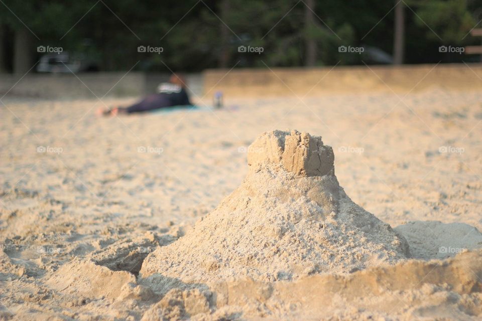 Sandcastle on the beach in summer