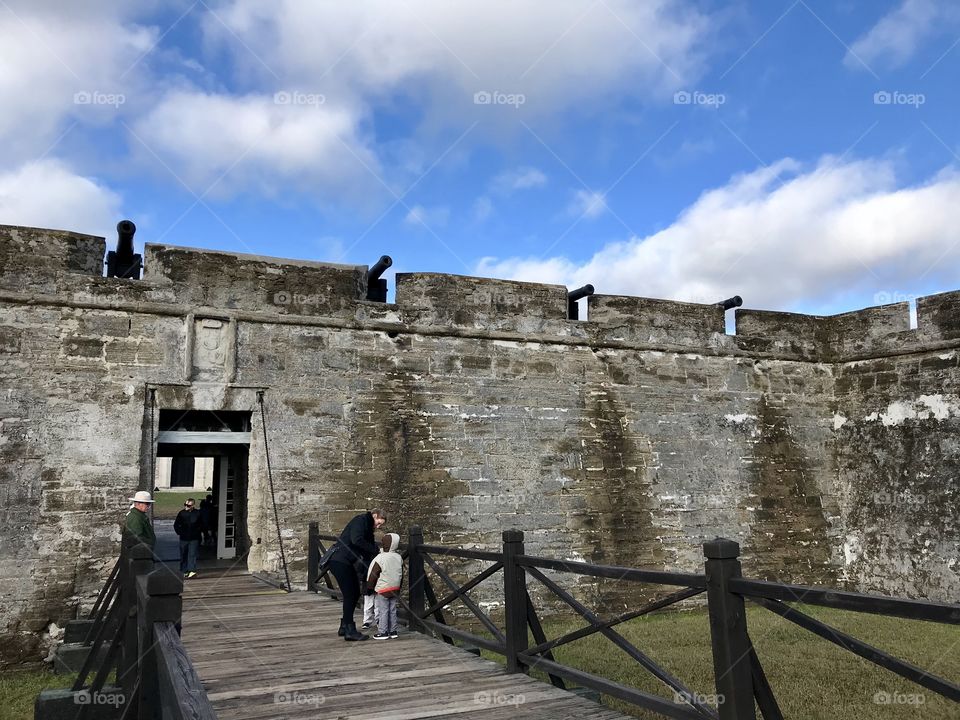 Tourists on the walkway leading into the historical fort in St. Augustine, Florida 