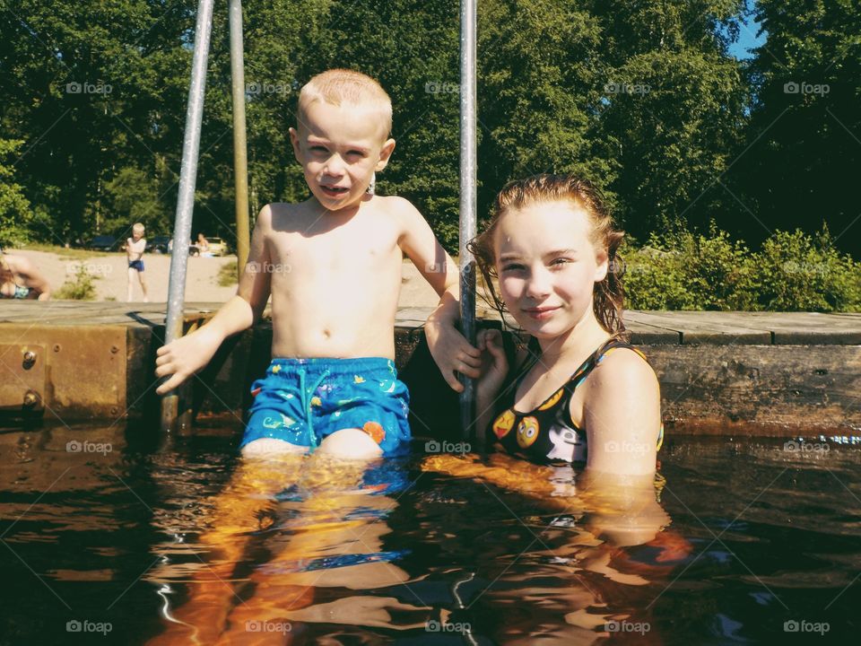 Siblings having funat the lake