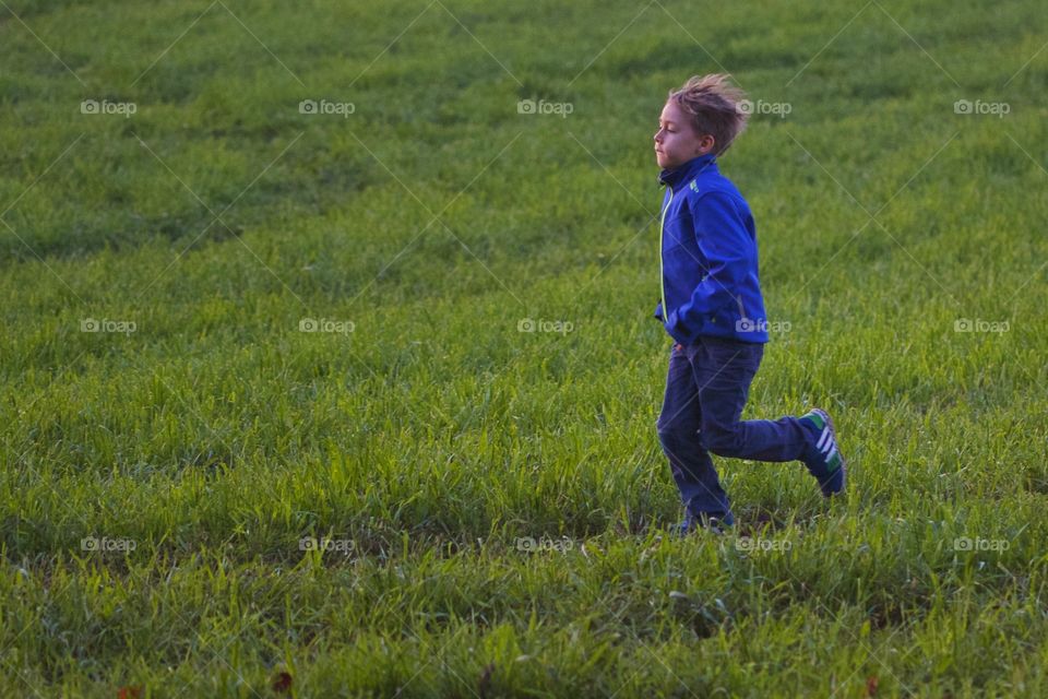 Cute child walking in grass