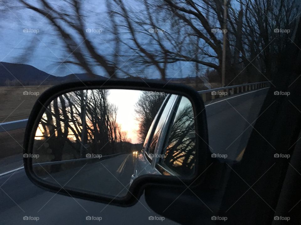 Looking back, sunset in the rear view mirror 