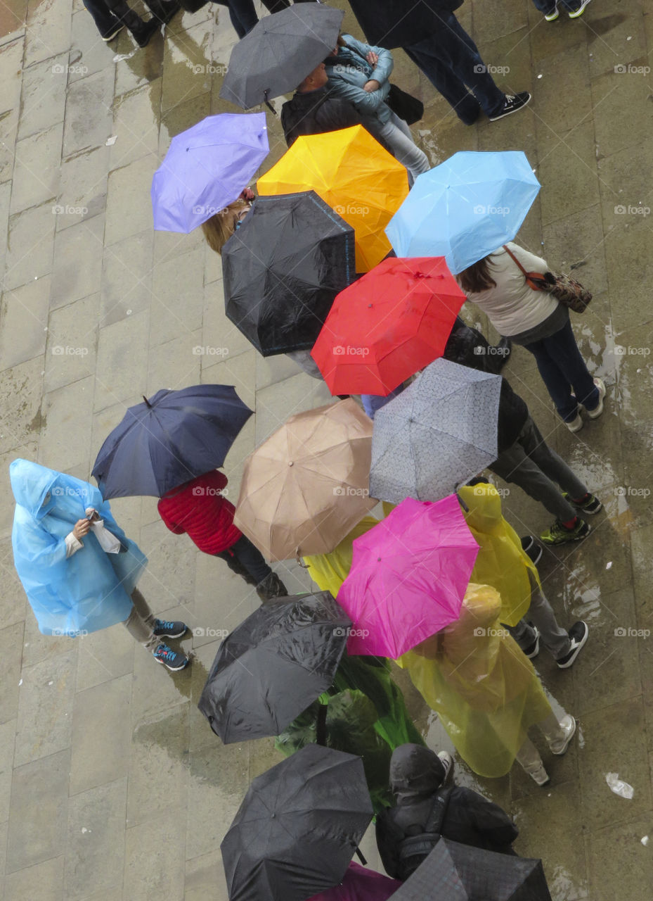 People with umbrellas from above