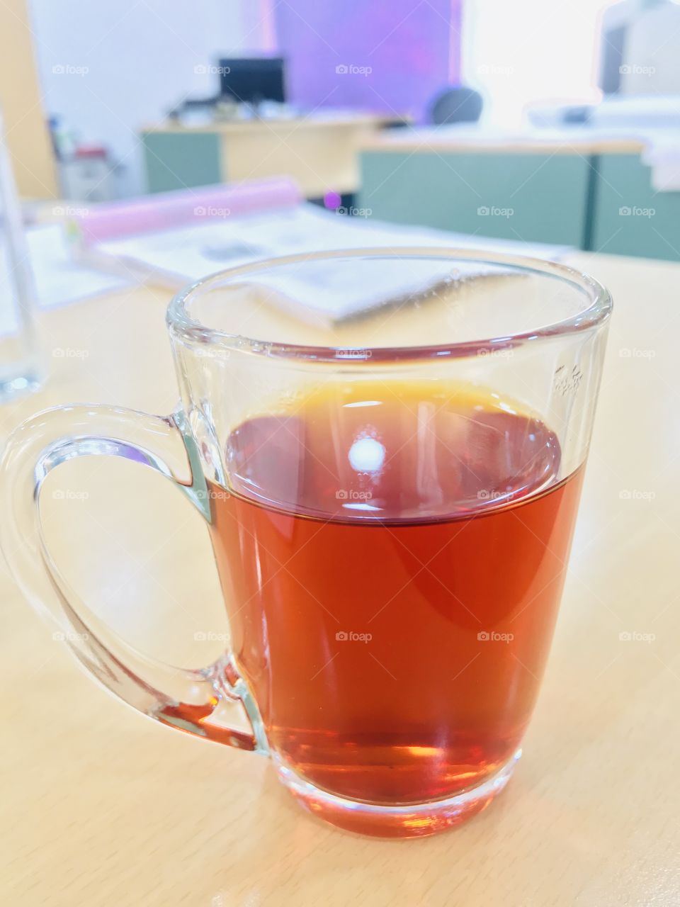 Refreshing cup of black tea in a transparent glass cup