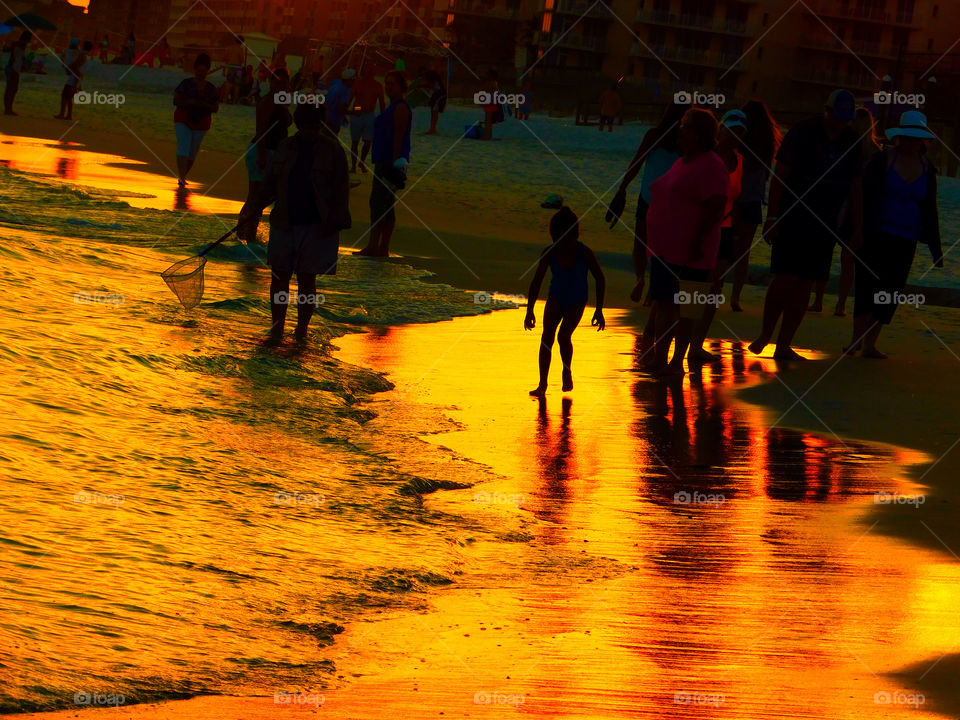 Walking along the beach silhouette 