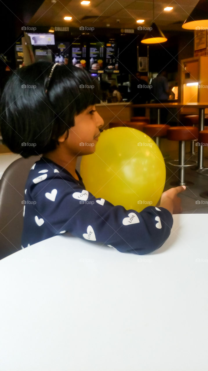 Smiling kid with a balloon