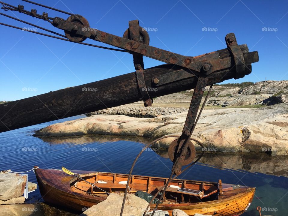 Old wooden boat and crane