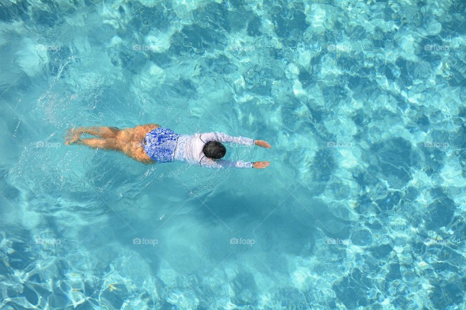 A woman swimming laps to stay fit. 