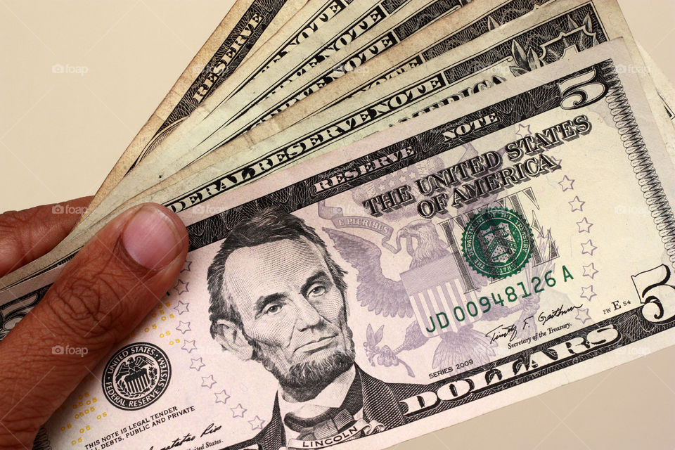 a currency in hand showing spending power