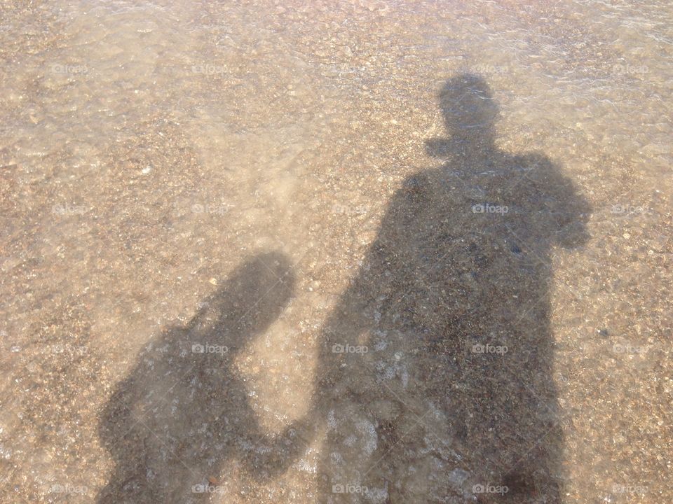 Beach shadow child father