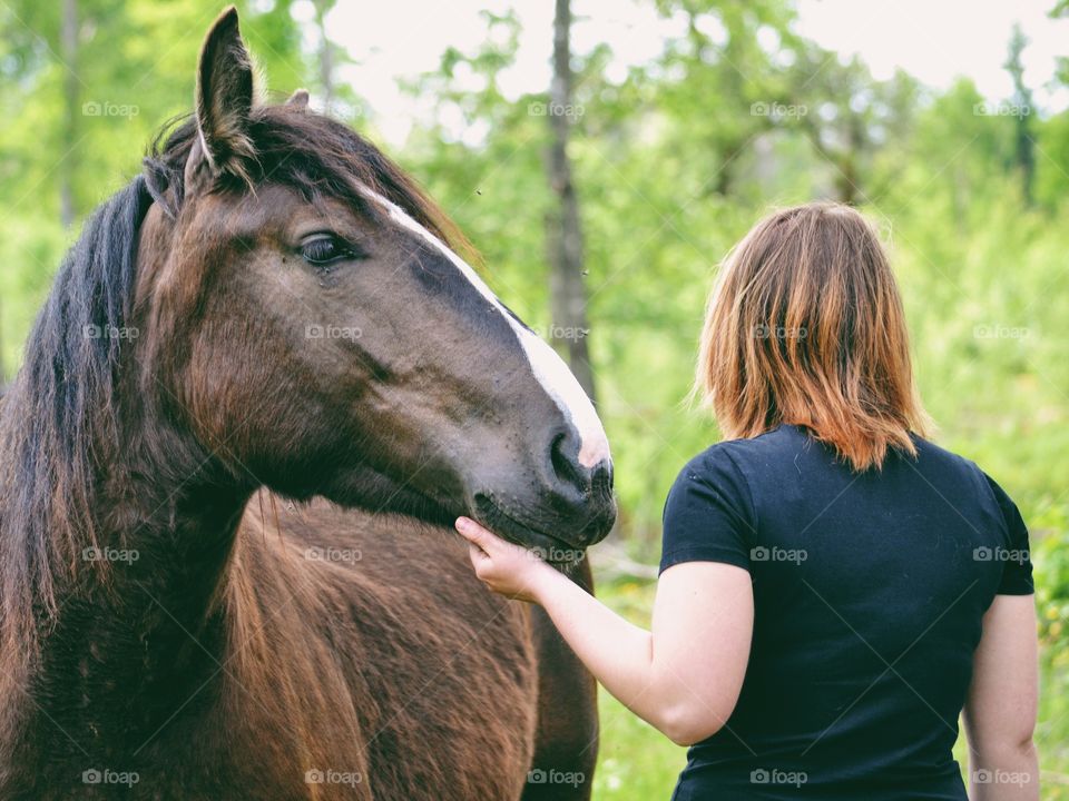 Woman and a horse in a cute moment