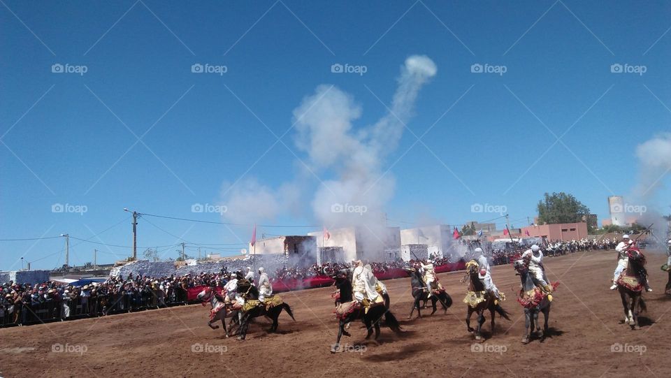 Horseback riders shoot from their guns