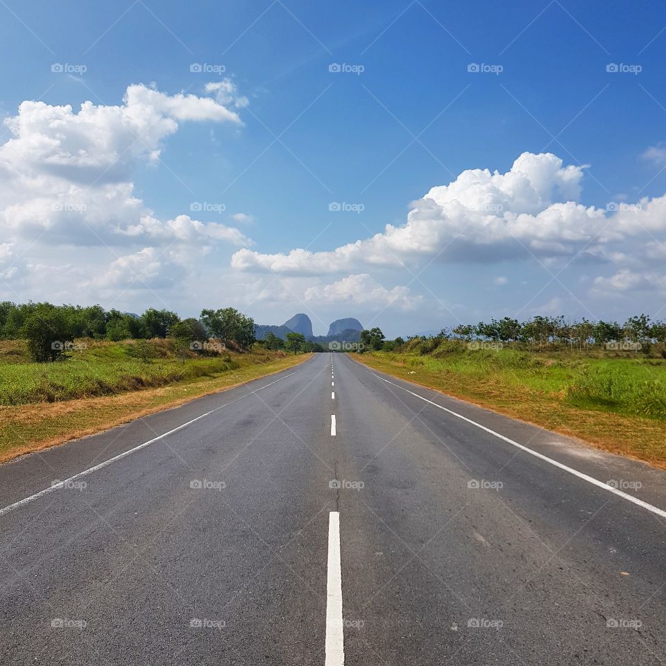 Scenic view of road against blue sky