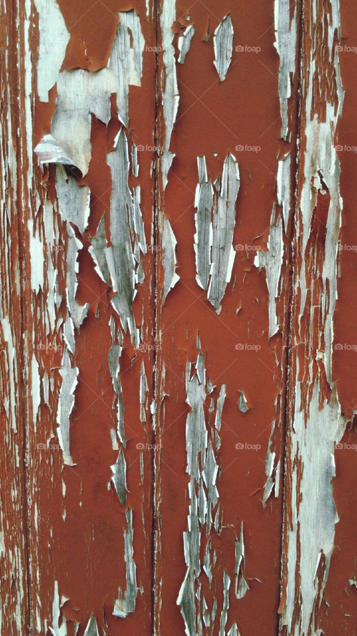 red peeling paint on wooden doors