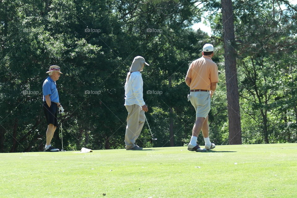 Men playing golf