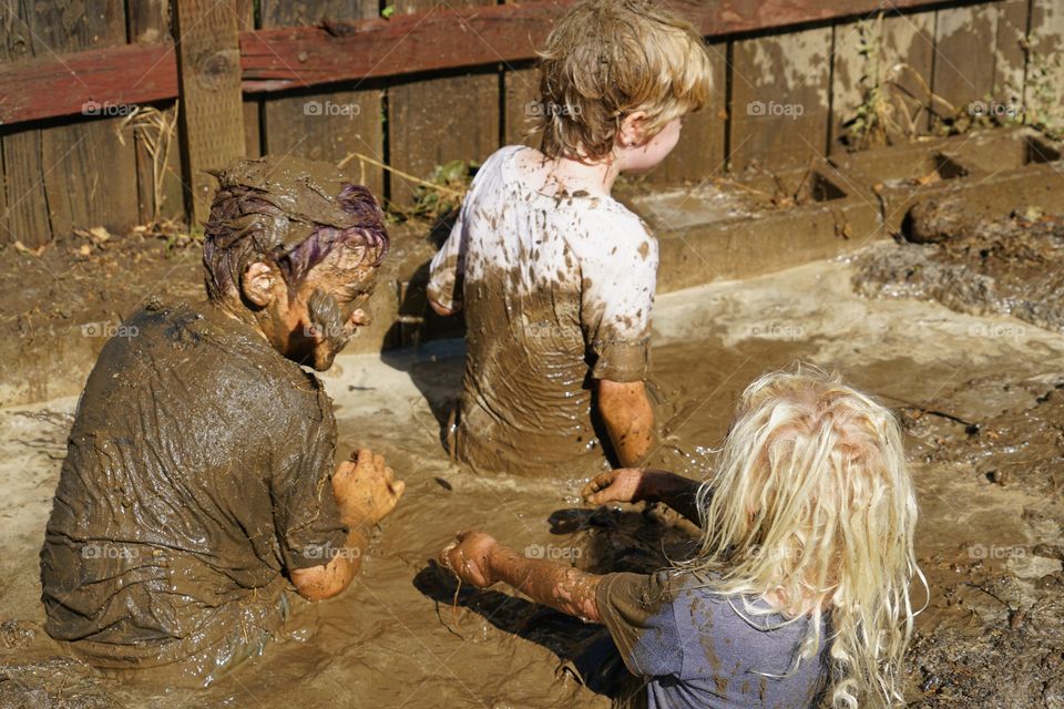 Brothers Playing In Mud