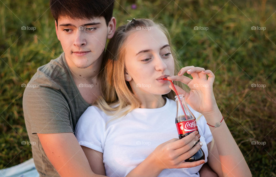 Teenage boy with Girl drinking cold drink