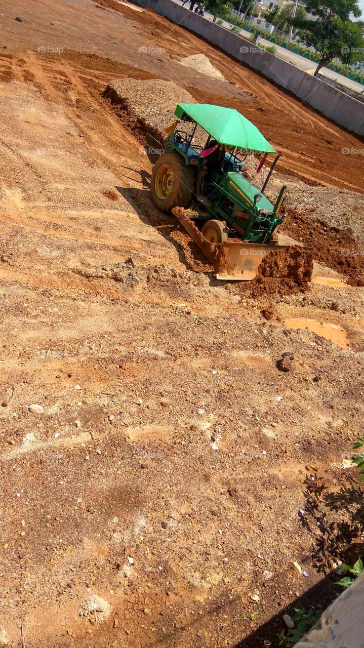 tractor doing work  the man operating