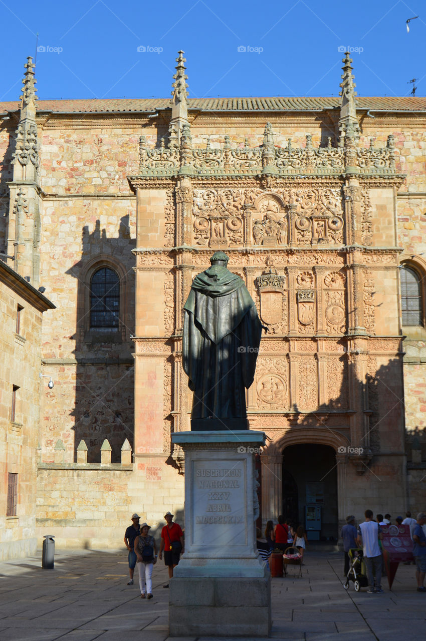 View of the façade of Salamanca University with statue of Fray Luis de León in the foreground - Salamanca, Spain.