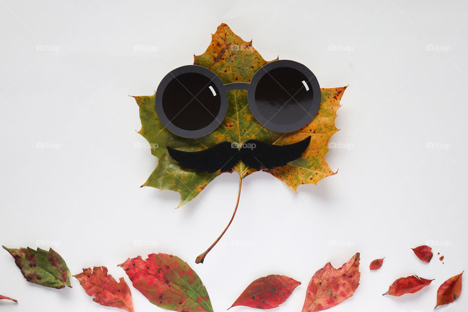 Autumn leaf with glasses and moustache