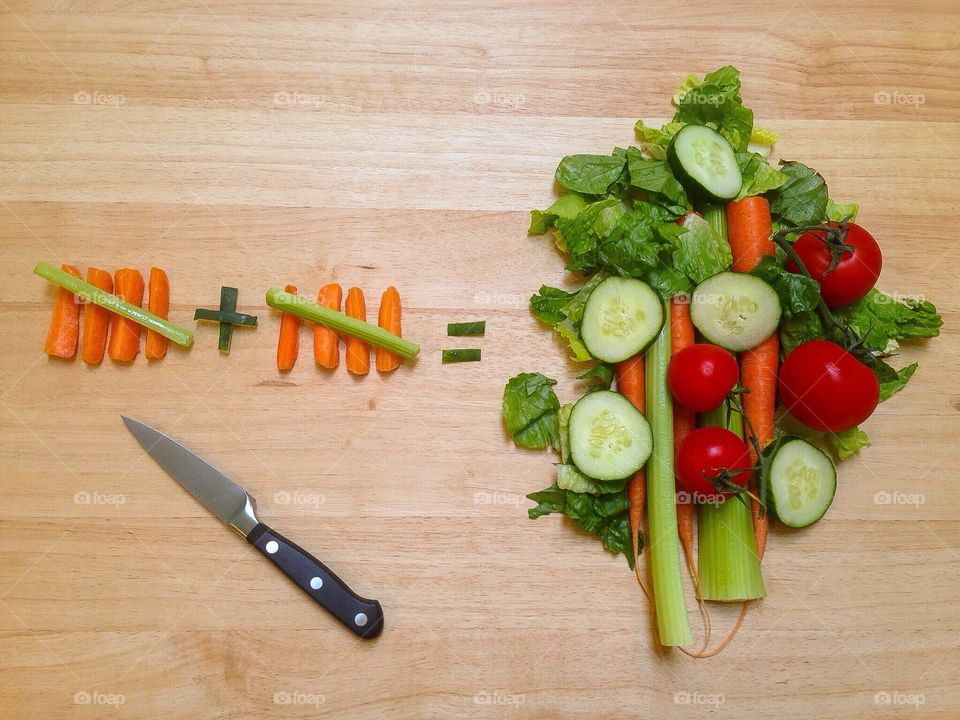 Vegetable and kitchen knife on table