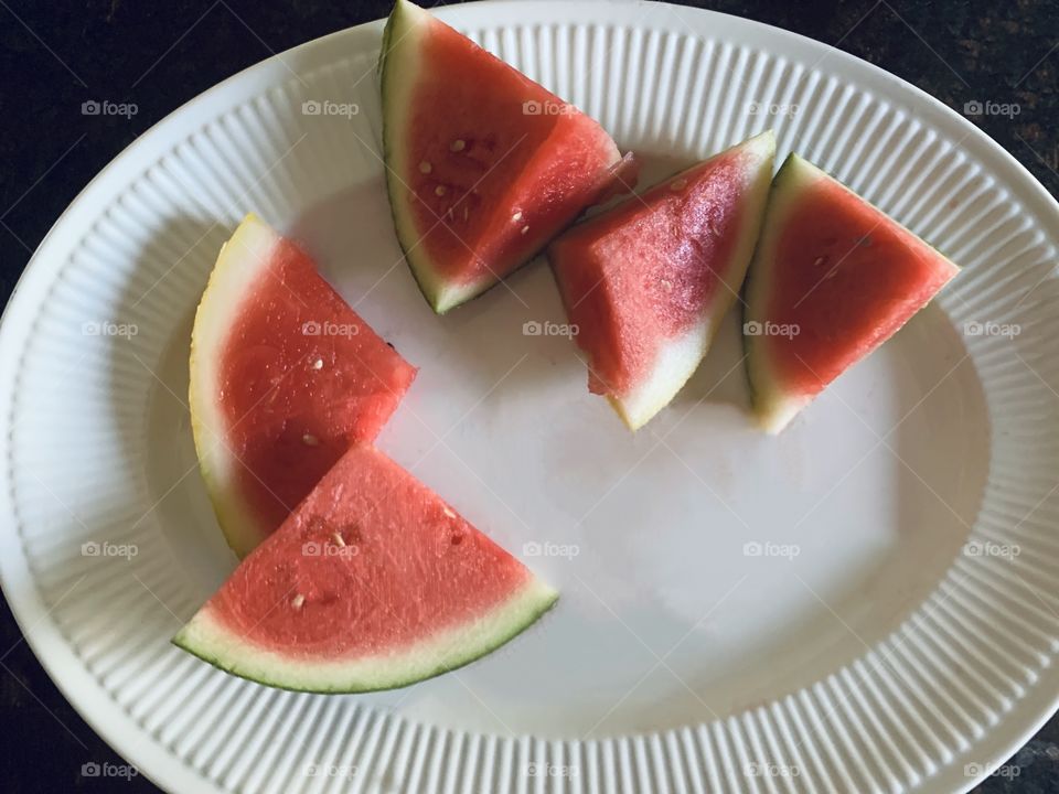 Plate of fresh watermelon slices for a tasty snack. 