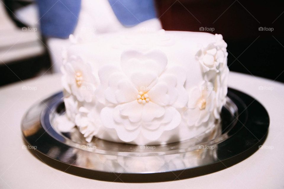 A cute minimalist wedding cake decorated as a bride's wedding dress