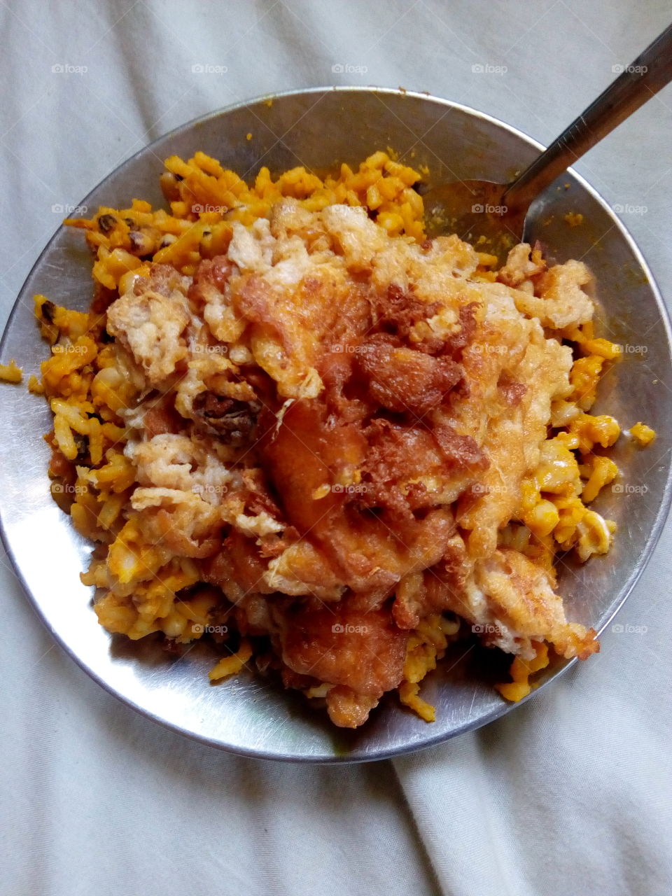cooked rice and beans with fried egg meal