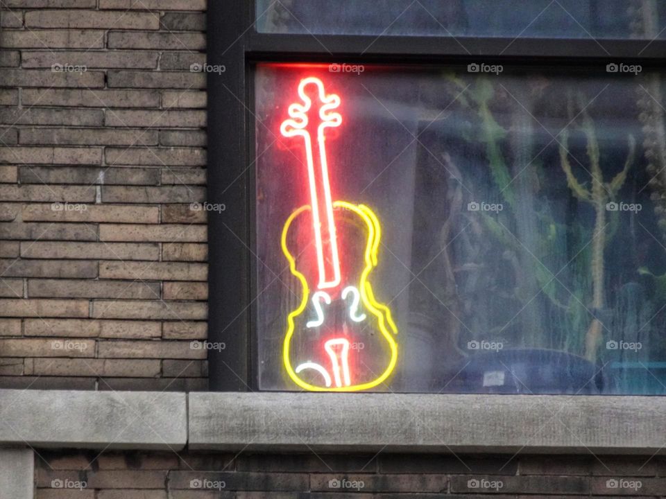 Neon guitar in the window 