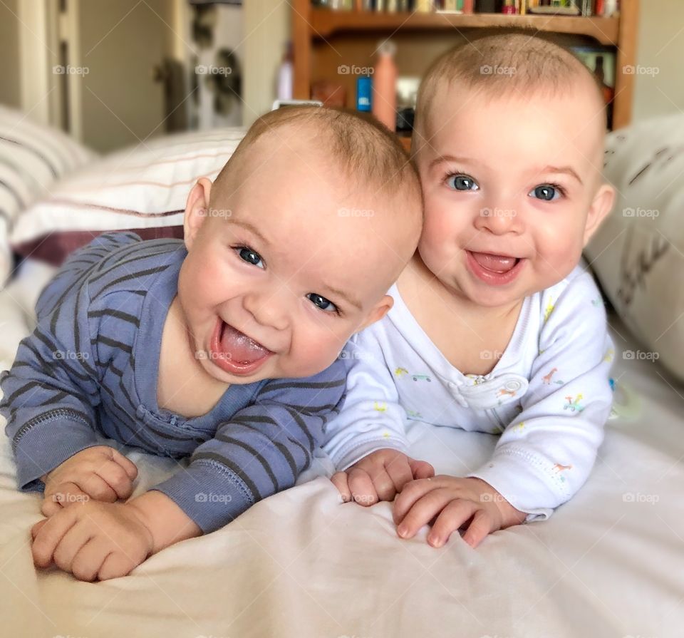 Smiling twin baby boys
