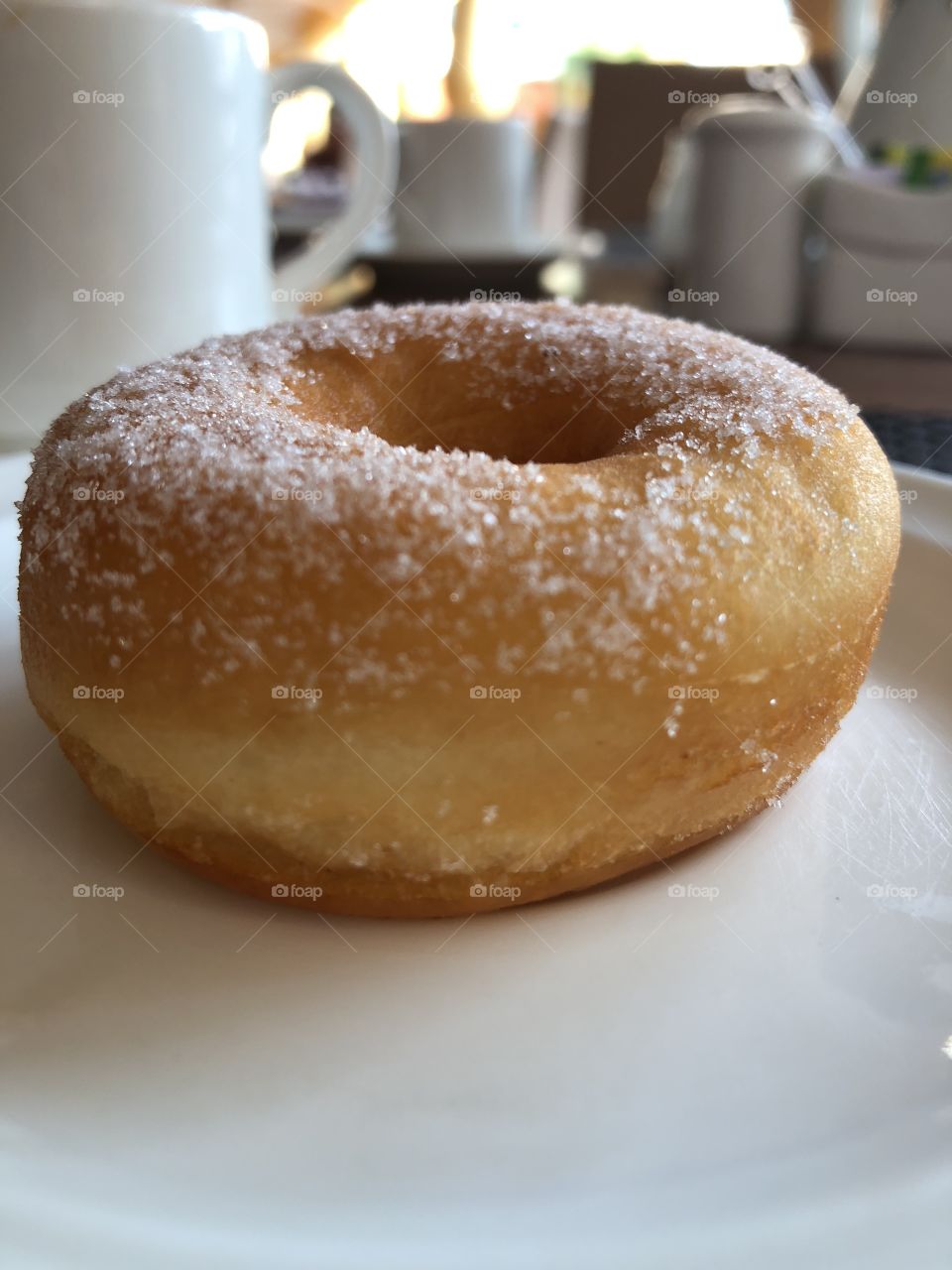 A Sugared Ring Doughnut & A Hot Drink 