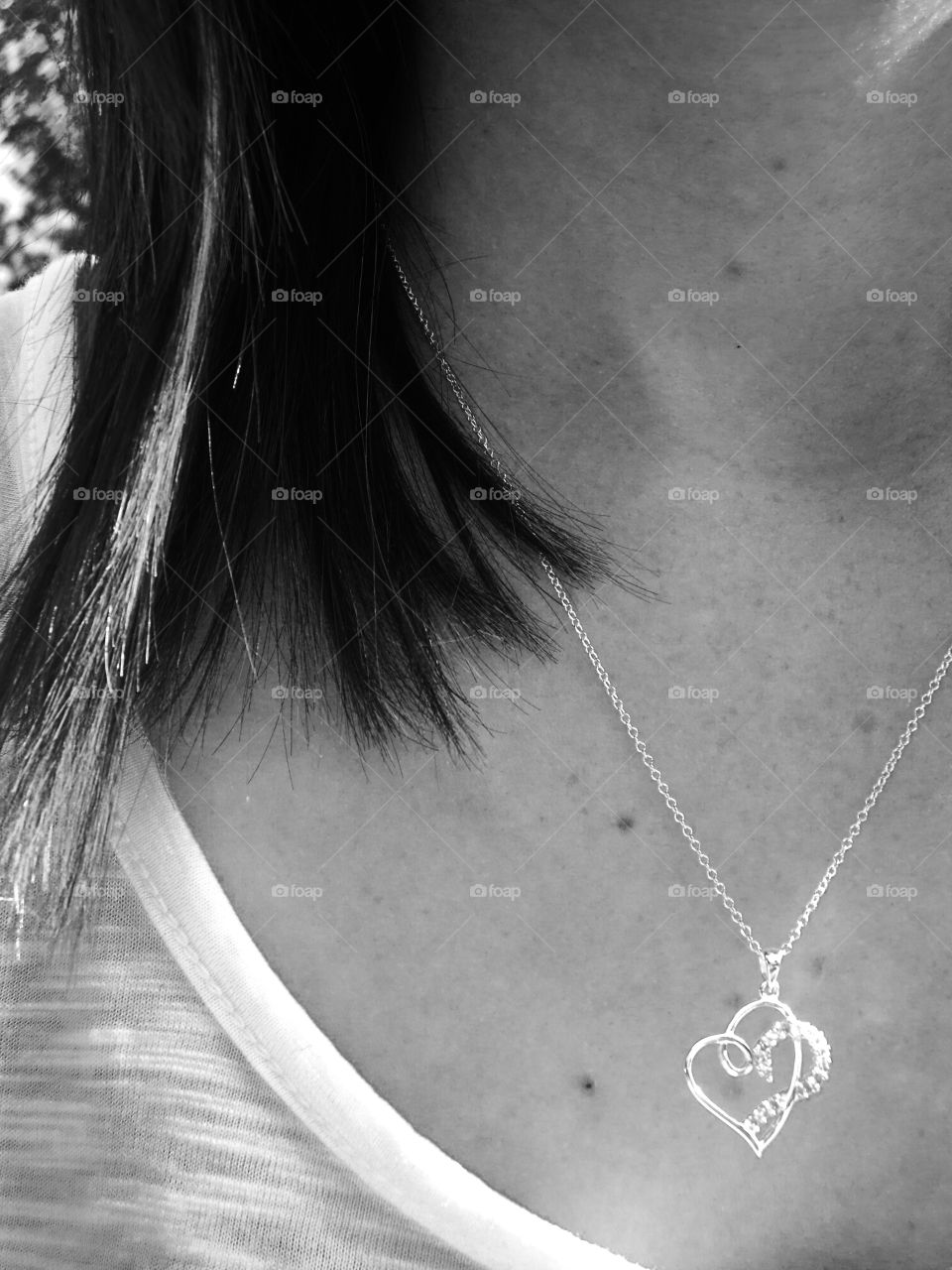 Heart shaped necklace around girl’s neck