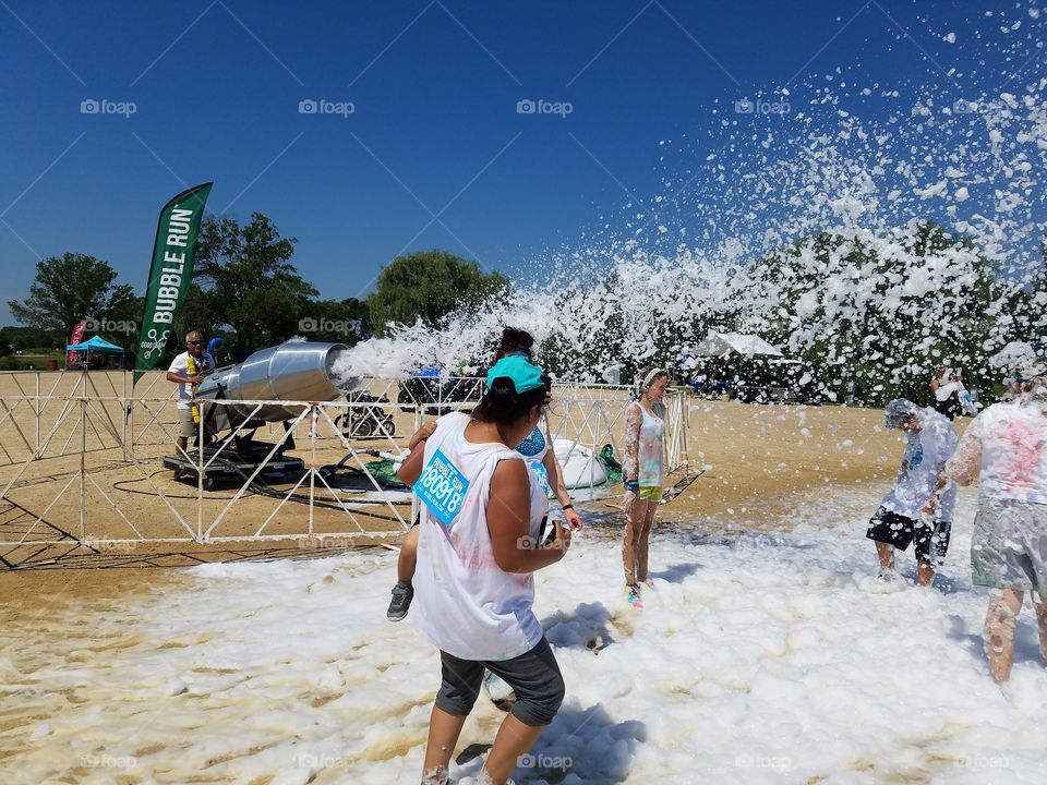 Foam machine throwing foam at bubble run festival