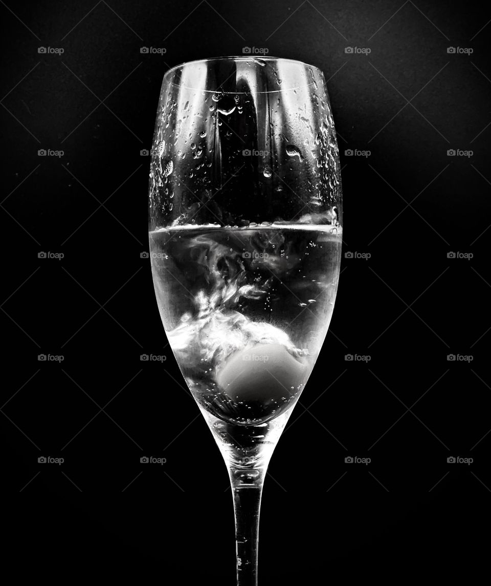 Olive drop in a champagne crystal; Black and White