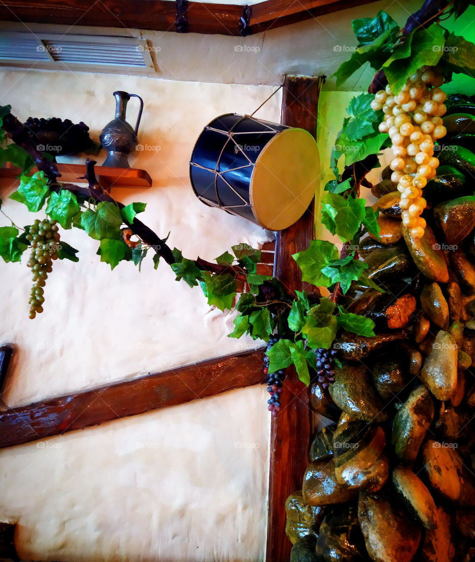 Oriental shades.  Oriental drum, shelf with oriental dishes, artificial grapes