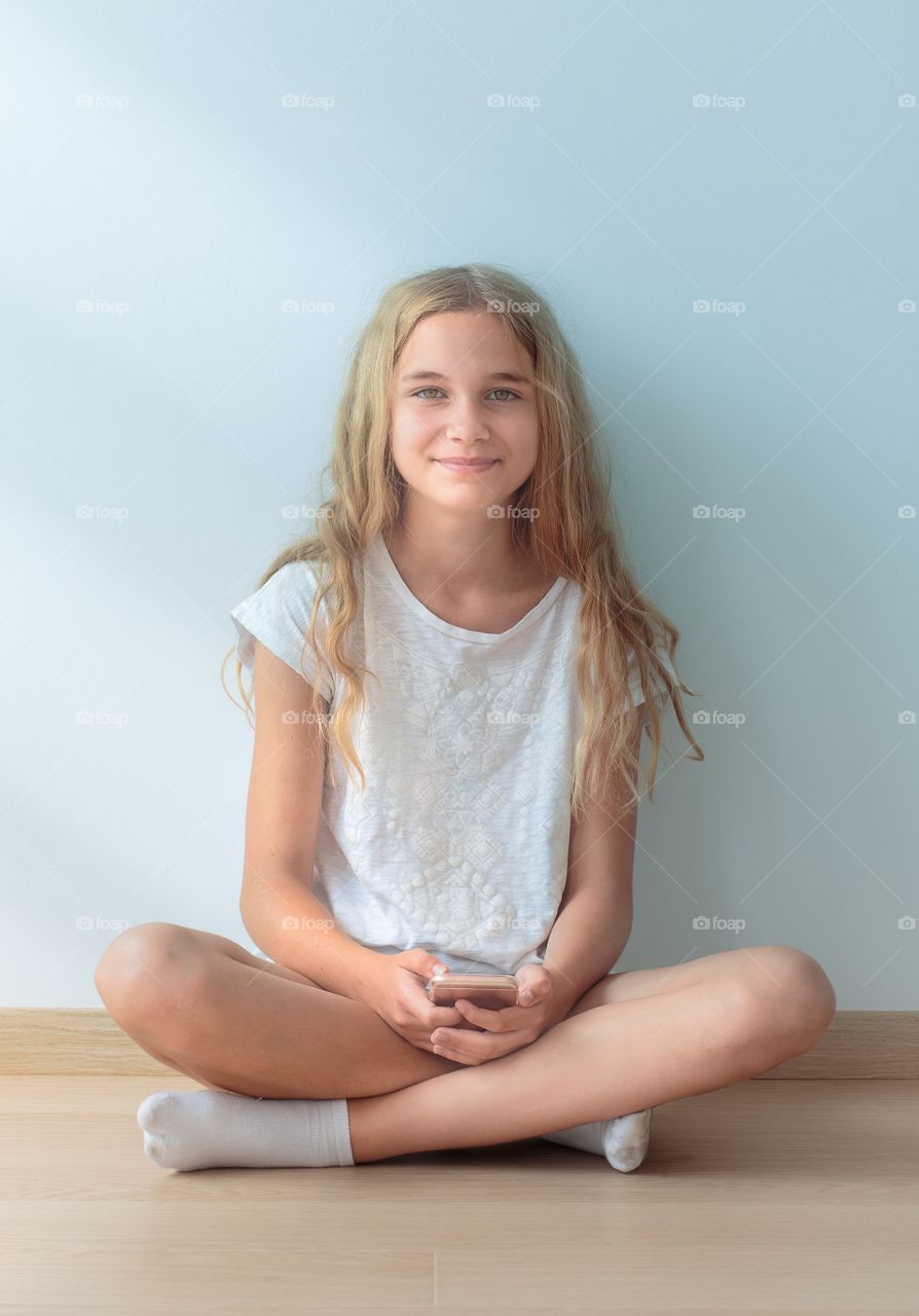 Girl sitting against wall