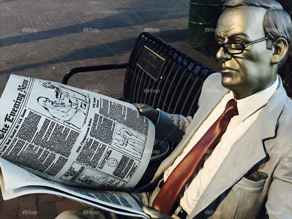 Bronze Businessman Statue Reading the Newspaper on Front Street in Downtown Harrisburg, PA