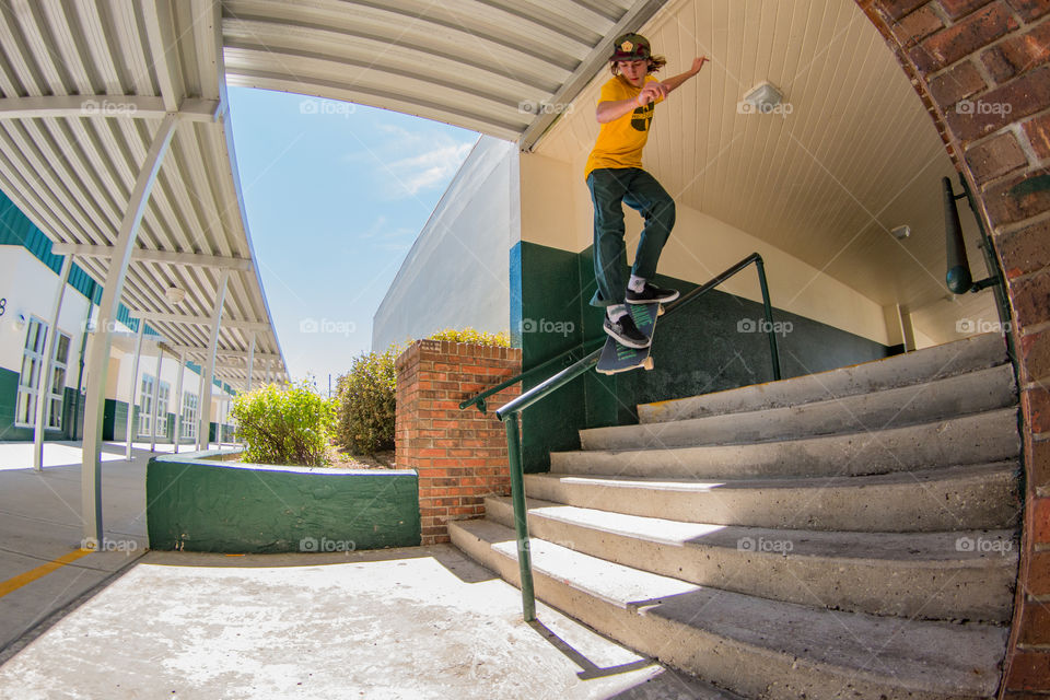 Skateboarder on a hand rail